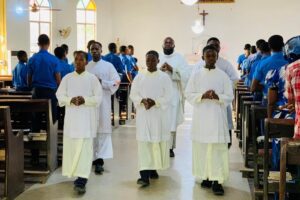 Alter servers and priest processing after a mass at Saints Simon and Jude Seminary